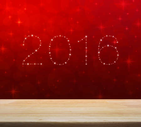 2016 from beautiful bright stars over empty wooden table and red blur light with shiny starry, New year backgroundの写真素材