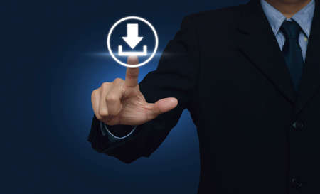 Businessman hand pushing button web download icon over blue backgroundの写真素材