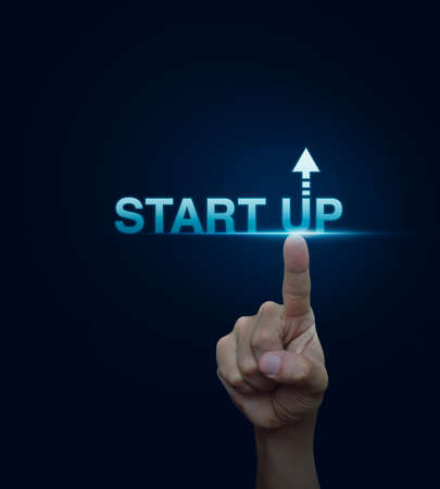 Hand click on start up icon over blue background, Start up business concept