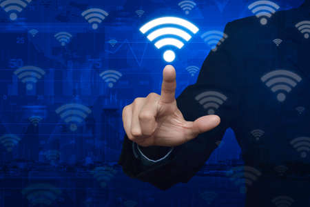 Businessman pointting wi-fi button over map and city background, Technology and internet concept,の写真素材