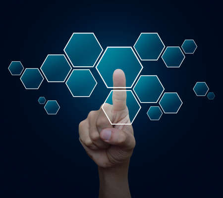 Man hand pushing blank modern virtual technology screen icon over blue backgroundの写真素材