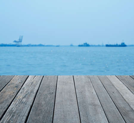 Empty old wood floor over blur of cargo ship with shipping port, for your product display montage
