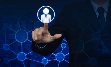 Businessman hand click businessman icon over world map and city towerの写真素材