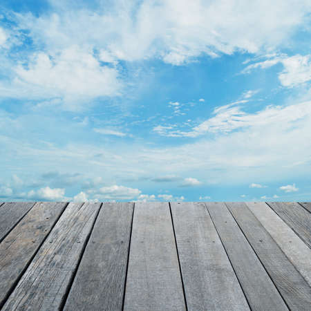 Empty old wood floor with blue sky with white clouds, for your product display montageの写真素材