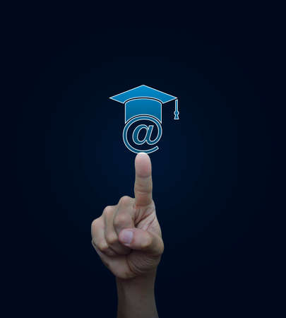 Hand pressing e-learning icon on blue background, Study online conceptの写真素材