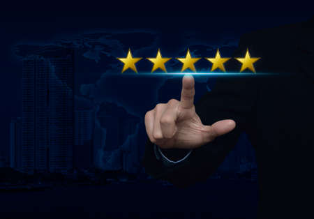 Businessman pressing five gold stars to increase rating over map and city tower, Feedback concept