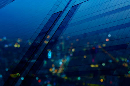 Aerial view of blur city tower reflection in window glass, blue toneの写真素材