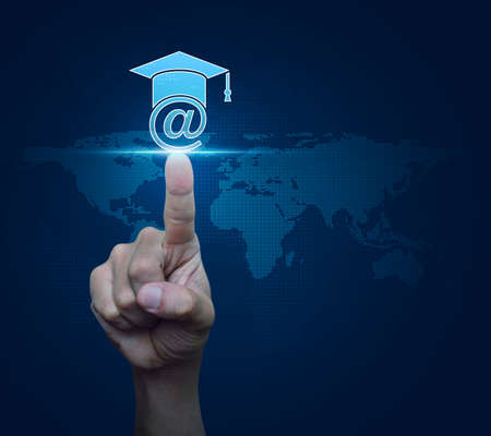 Hand pressing e-learning icon over digital world map blue background, Study online conceptの写真素材