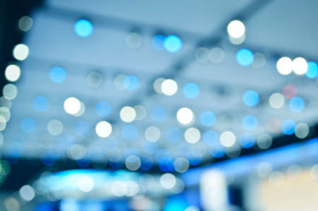 Defocused light and shadow of shopping mall, blue tone, abstract backgroundの写真素材