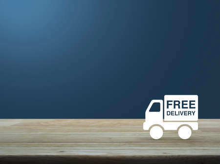 Free delivery truck icon on wooden table over light blue gradient background, Transportation business conceptの写真素材
