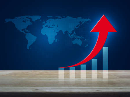 Red arrow with graph on wooden table over digital world map blue tone background, Success business concept, Elements of this image furnished by NASAの写真素材