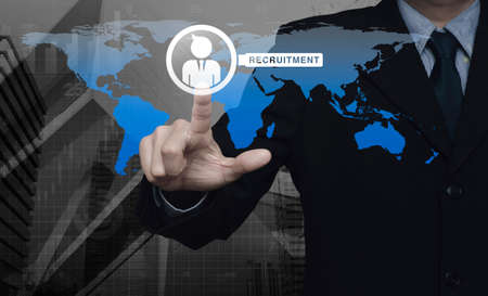 Hand pressing businessman with magnifying glass icon over map and city tower, Recruitment concept, Elements of this image furnished by NASAの写真素材