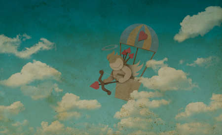 Cupid shoot bow in hot air balloon made from recycled paper on blue sky, vintage style, Valentines day conceptの写真素材