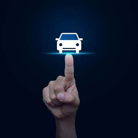 Hand pressing car front view flat icon over blue background, Business service car conceptの写真素材