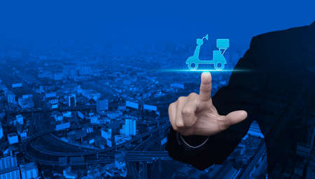 Businessman pressing motor bike icon over modern city tower, street and expressway, Business...