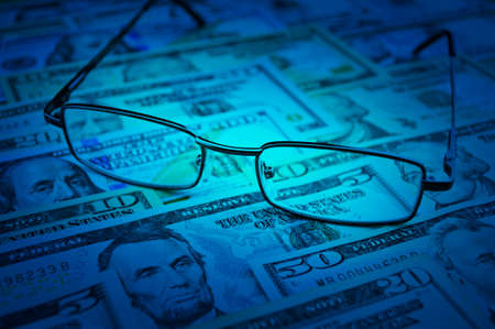 Glasses on dollar money, blue tone, Business financial conceptの写真素材