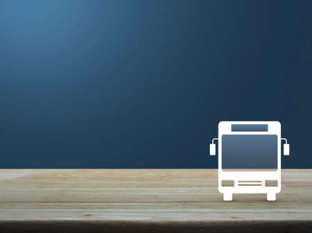 Bus flat icon on wooden table over light blue gradient background, Business transportation service conceptの写真素材
