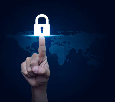 Hand pressing key icon over digital world map, Business security concept