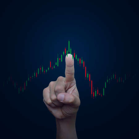 Hand pressing to trading graph of stock market over gradient light blue background, Business investment conceptの写真素材