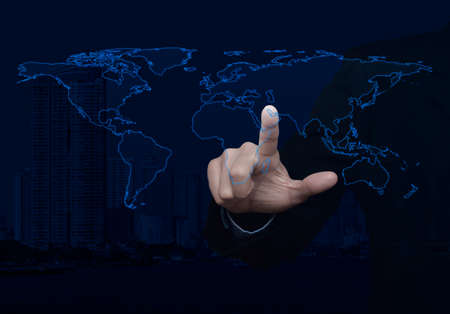 Businessman touching blank global world map on modern office city towerの写真素材