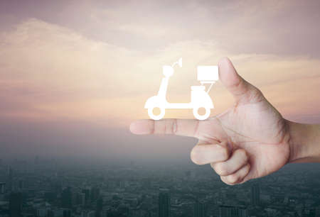 Motor bike icon on finger over city tower at sunset, vintage style, Business delivery service...
