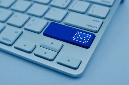 Mail flat icon on modern computer keyboard button, Contact us conceptの写真素材