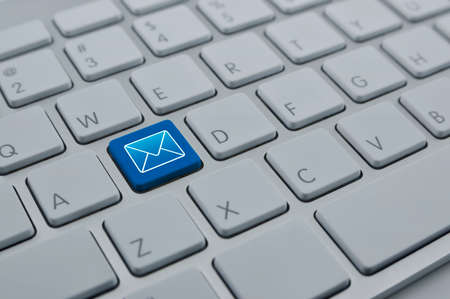 Mail flat icon on modern computer keyboard button, Contact us conceptの写真素材