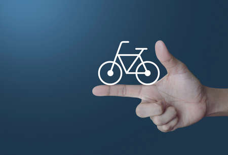 Bicycle flat icon on finger over light gradient blue background, Healthy lifestyle conceptの写真素材