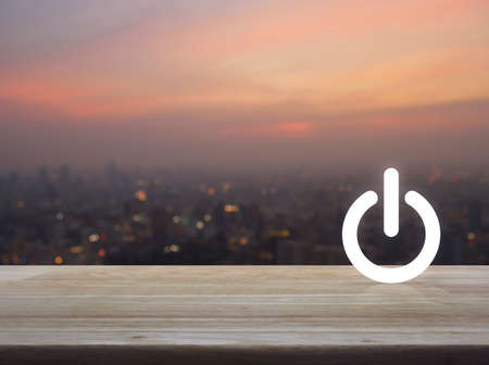 Power button icon over blur of cityscape on warm light sundown, Start up business conceptの写真素材