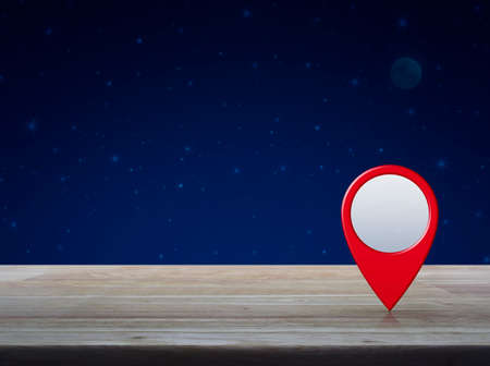 Map pin location button on wooden table over fantasy night sky and moon, Map pointer navigation conceptの写真素材