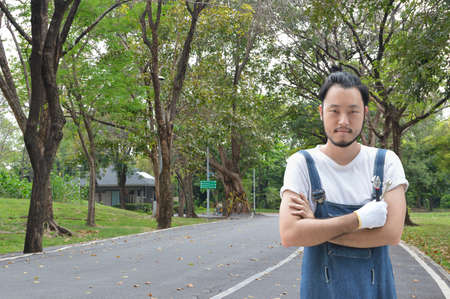 Asian mechanic car engine in uniform with tools over road with trees and forest, Business repair car...