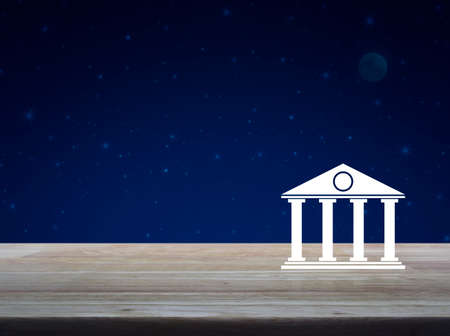 Bank icon on wooden table over fantasy night sky and moon, Business banking online conceptの写真素材