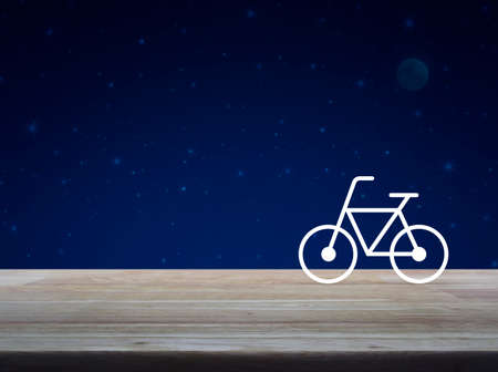 Bicycle flat icon on wooden table over fantasy night sky and moon, Healthy lifestyle conceptの写真素材