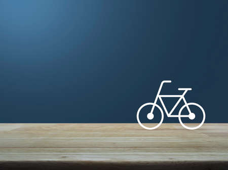 Bicycle flat icon on wooden table over light gradient blue background, Healthy lifestyle concept