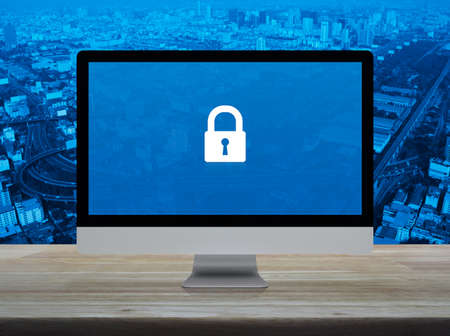 Padlock flat icon with modern laptop computer on wooden table over city tower, street, expressway...