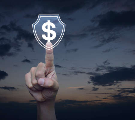 Hand pressing dollar with shield flat icon over sunset sky, Business money insurance and protection...