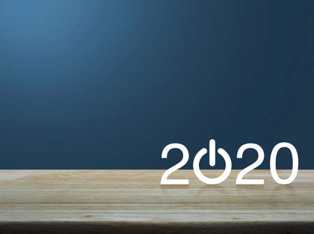 2020 start up business flat icon on wooden table over light blue gradient background, Happy new year 2020 conceptの写真素材