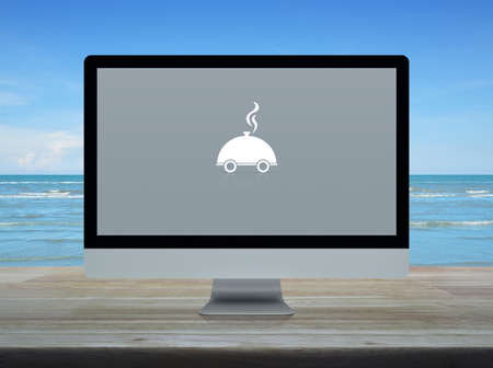 Restaurant cloche flat icon on desktop modern computer monitor screen on wooden table over tropical...