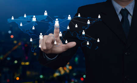 Hand click businessman icon with world map connection lines over blur colorful night light city...
