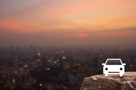 Taxi car flat icon on rock mountain over blur of cityscape on warm light sundown, Business transportation service conceptの写真素材