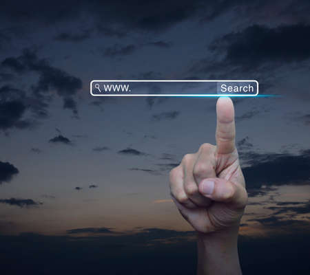 Hand pressing search www button over sunset sky, Technology searching internet online conceptの写真素材