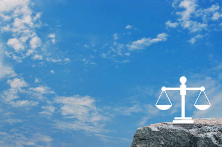 Law flat icon on rock mountain over blue sky with white clouds, Business legal service conceptの写真素材