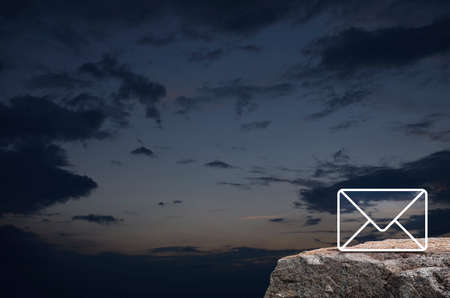 email flat icon on rock mountain over sunset sky, Business customer service and support online conceptの写真素材