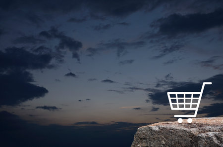 Shopping cart flat icon on rock mountain over sunset sky, Business shop online conceptの写真素材