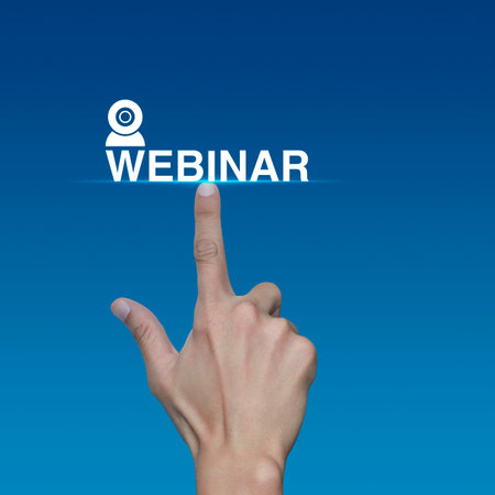 Hand pressing webinar flat icon over light blue background, Business seminar online conceptの写真素材