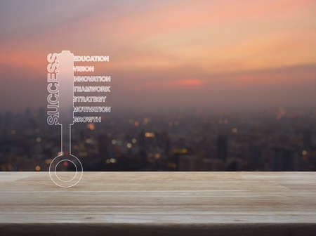 Key with business words on wooden table over blur of cityscape on warm light sundown, Business...