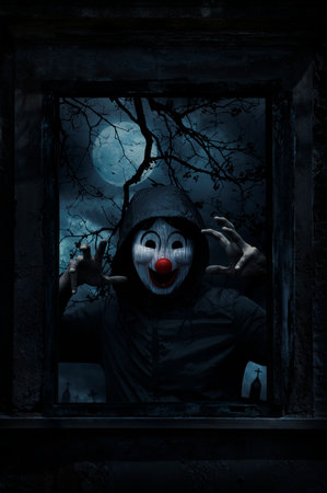 Scary evil clown wear jacket standing in old damaged wood window with wall over cross, church,...