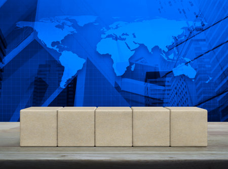 Five wood block cubes on wooden table over world map, modern office city tower and skyscraper