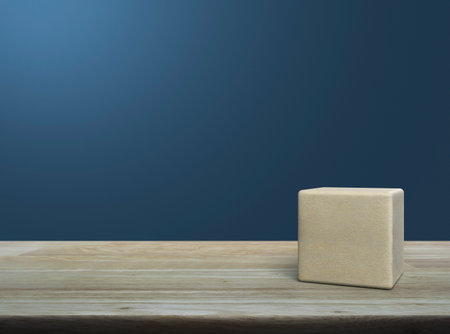 Wood block cube on wooden table over light blue wallの写真素材