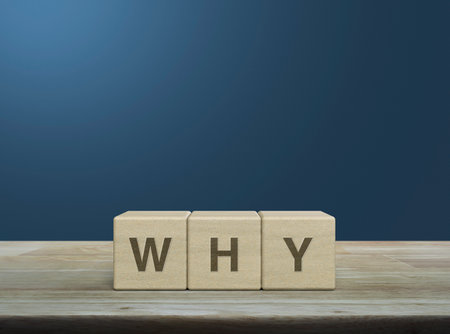 Why letter on wood block cubes on wooden table over light blue wall, Business communication conceptの写真素材